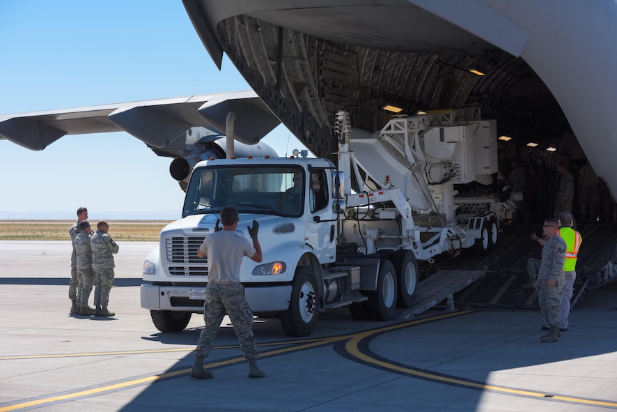 Airmen assigned to the 266th Range Squadron unload a threat emitter from a Royal Australian Air Force C-17 Globemaster III at Mountain Home Air Force Base, Idaho, Aug 22, 2016. The threat emitters played a role in Australia's larget multi-national exercise, Pitch Black. (U.S. Air Force photo by Senior Airman Connor J. Marth)