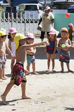 A Japanese local preschooler throws a water balloon during a water fight at Midoro Hoikuen in Iwakuni, Japan, Aug. 23, 2016. The Marine Memorial Chapel had been hosting community relations preschool visits for 12 years, and gives Marine Corps Air Station Iwakuni residents an opportunity to volunteer their time with local Japanese children. (U.S. Marine Corps photo by Lance Cpl. Joseph Abrego)