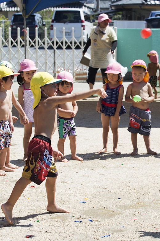A Japanese local preschooler throws a water balloon during a water fight at Midoro Hoikuen in Iwakuni, Japan, Aug. 23, 2016. The Marine Memorial Chapel had been hosting community relations preschool visits for 12 years, and gives Marine Corps Air Station Iwakuni residents an opportunity to volunteer their time with local Japanese children. (U.S. Marine Corps photo by Lance Cpl. Joseph Abrego)
