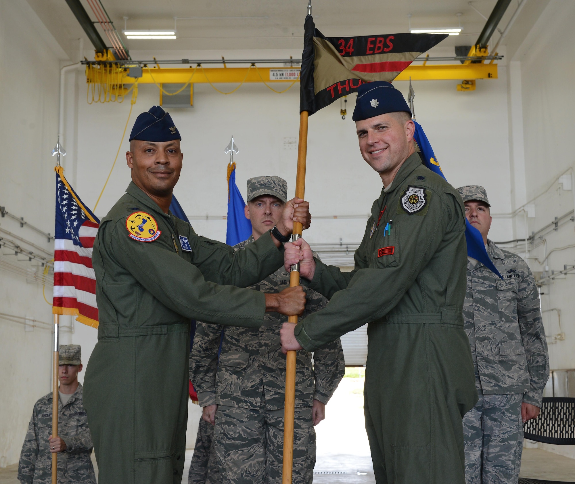 Lt. Col. Seth Spanier, right, 34th Expeditionary Bomb Squadron commander, accepts the 34th EBS guidon from Col. Samuel G. White III, 36th Operations Group commander, during a transfer of authority ceremony at Andersen Air Force Base, Guam, Aug. 15, 2016. The ceremony solidified the responsibility of the U.S. Pacific Command’s Continuous Bomber Presence being passed from the 69th EBS from Minot Air Force Base, N.D., to the 34th EBS from Ellsworth Air Force Base, S.D. (U.S. Air Force photo by Airman 1st Class Arielle Vasquez)