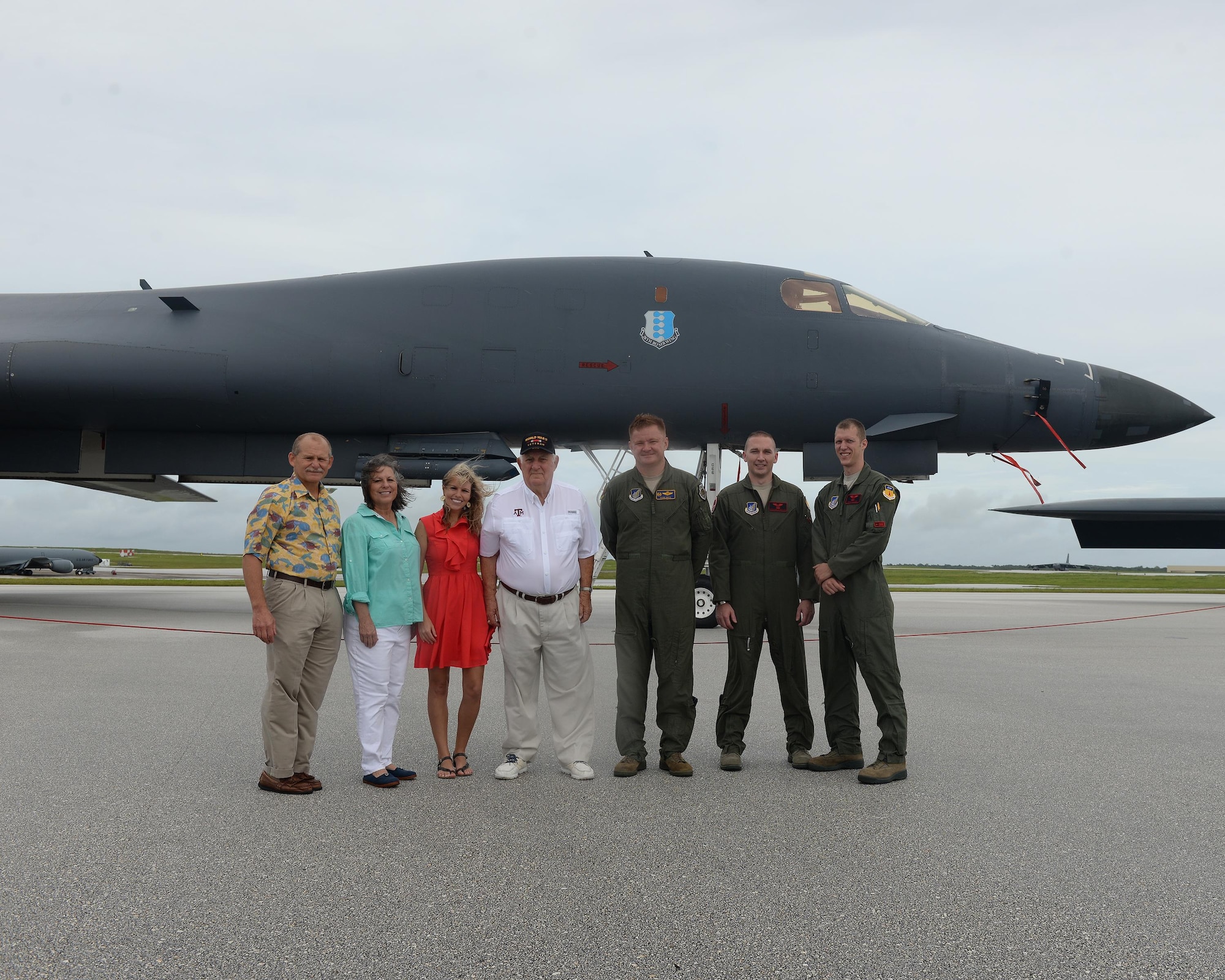 Rowland Ball, a World War II veteran, family members and Team Andersen Airmen pose for a photo in front of a B-1B Lancer during a visit to Andersen Air Force Base, Guam, Aug. 16, 2016. Ball served in the United States Army Air Corps as a B-29 Superfortress navigator during the tail end of World War II, where he flew 27 missions out of Guam. (U.S. Air Force photo by Staff Sgt. Benjamin Gonsier)