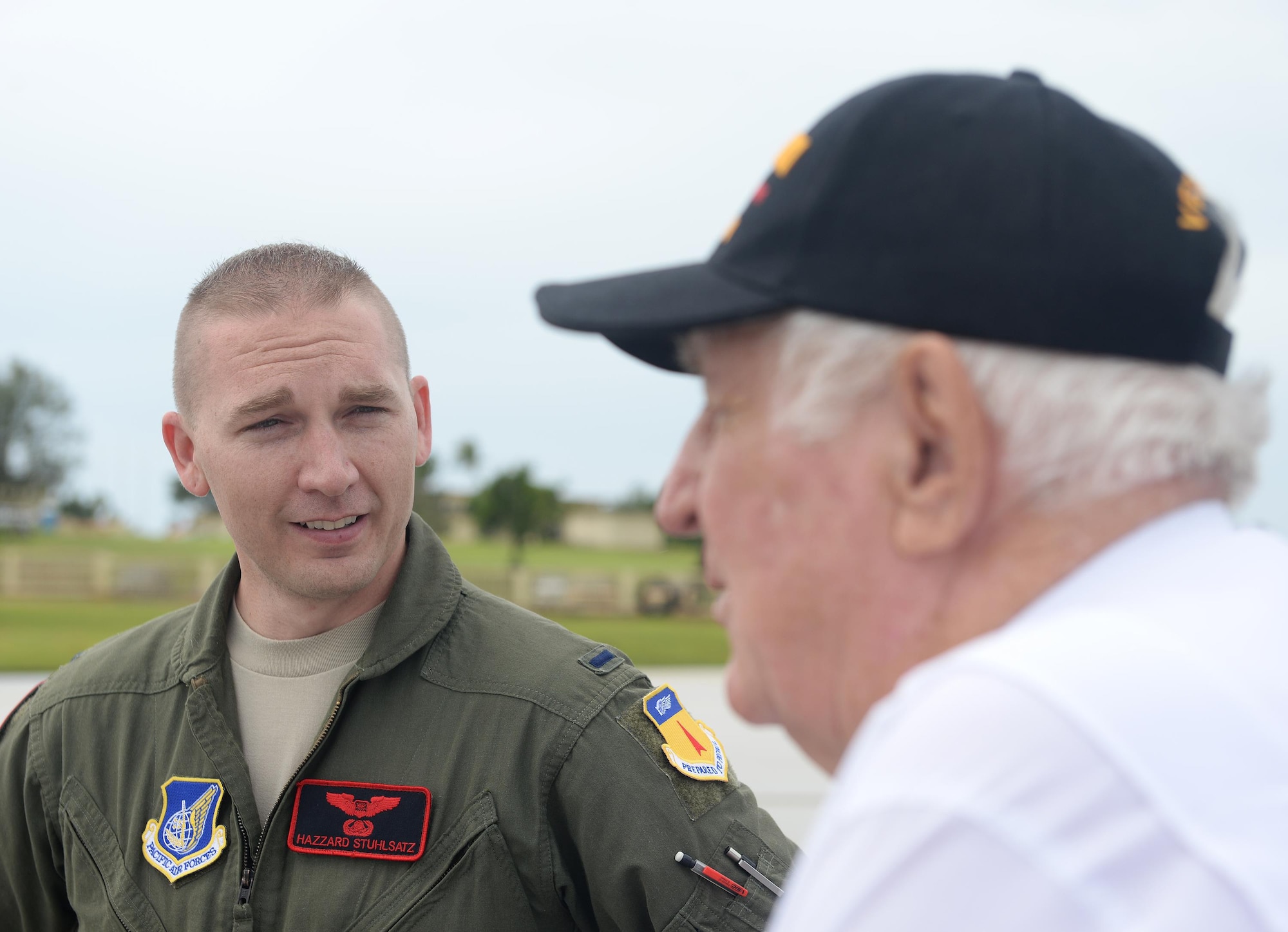 1st Lt. Dillen Stuhlsatz, a 34th Expeditionary Bomb Squadron weapons systems officer deployed from Ellsworth Air Force Base, S.D., shares a flying experience with World War II veteran Rowland Ball at Andersen Air Force Base, Guam, Aug. 16, 2016. Ball, who returned to Guam for the first time in 71 years, received the opportunity to tour Andersen AFB and shared stories with Airmen about the challenges he faced during World War II. (U.S. Air Force photo by Staff Sgt. Benjamin Gonsier)