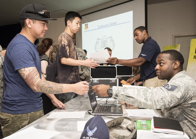 Eastside tower residents receive keys to their contingency housing apartments at Yokota Air Base, Japan, Aug 23, 2016. The 374th Civil Engineer Squadron and 374th Force Support Squadron worked together to temporarily relocate more than 300 families after Tropical Storm Mindulle caused power outages in residential towers. (U.S. Air Force photo by Airman 1st Class Baker/Released)