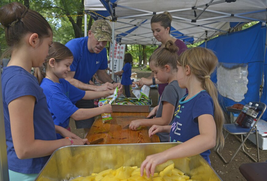 Members of Yokota Air Base prepare food for homeless people at Ueno Park, Tokyo, Japan, Aug. 19, 2016. The Yokota Air Base Chapel has worked with local churches for approximately 10 years to provide help for homeless people. (U.S. Air Force photo by Senior Airman David Owsianka/Released)
