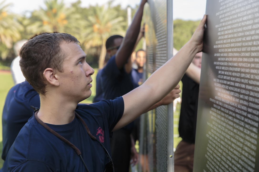 John S. Landry, a poolee with Marine Corps Recruiting Substation New Orleans and RSS Houma, helps assemble an 80-percent scale replica of the Vietnam Wall at the Goldring/Woldenberg Great Lawn in City Park, New Orleans, Aug. 25, 2016. The Marine Corps brought the wall to New Orleans as part of a commemorative plan to honor and remember the 50th anniversary of the Vietnam War. The wall arrived in conjunction with Marine Forces Reserve’s Centennial celebration, which began with events in New Orleans this week. (U.S. Marine Corps photo by Sgt. Ian Leones/Released)