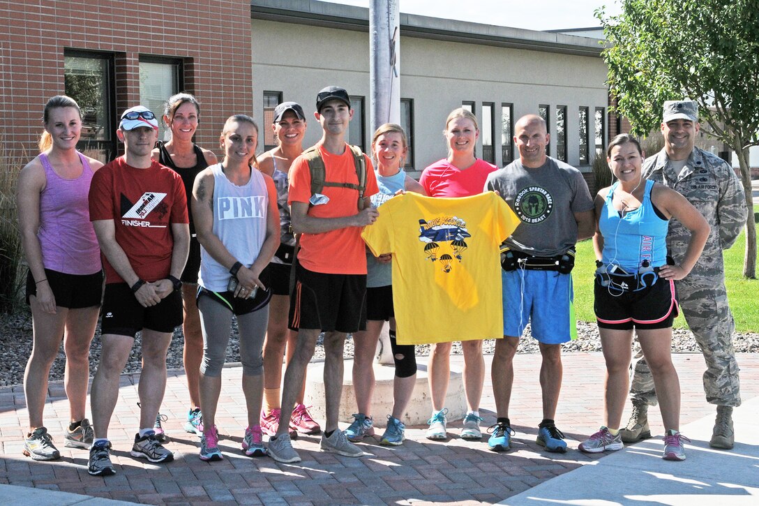 A portion of the 17 member marathon team pose for a group shot before a training run for the Air Force Marathon at the 120th Airlift Wing in Great Falls, Mont. Aug. 15, 2016. The 20th annual AF Marathon will be located in Dayton, Ohio, Sept. 17. (U.S. Air National Guard photo/Staff Sgt. Lindsey Soulsby/Released)