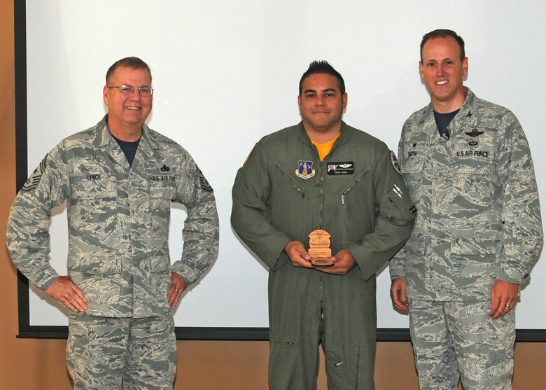 120th Airlift Wing Commander Col. Lee Smith and 120th AW Command Chief, Chief Master Sgt. Steven Lynch, present the Field Grade Officer of the Quarter Award to Maj. Tirso Pena during a commander’s call held in the Larsen Room of the Wing Headquarters Building during the regularly scheduled drill August 13, 2016. (U.S. Air National Guard photo by Staff Sgt. Lindsey Soulsby)
