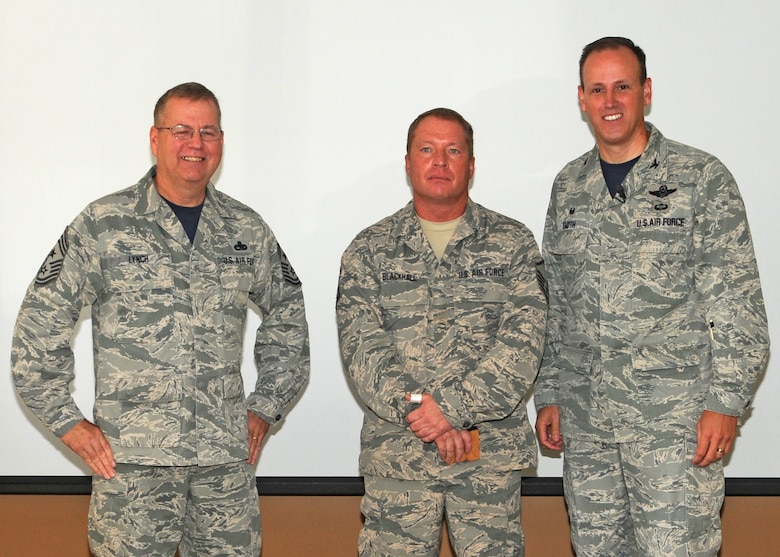 120th Airlift Wing Commander Col. Lee Smith and 120th AW Command Chief, Chief Master Sgt. Steven Lynch, present the Senior Noncommissioned Officer of the Quarter Award to Master Sgt. Mike Blackhall during a commander’s call held in the Larsen Room of the Wing Headquarters Building during the regularly scheduled drill August 13, 2016. (U.S. Air National Guard photo by Staff Sgt. Lindsey Soulsby)
