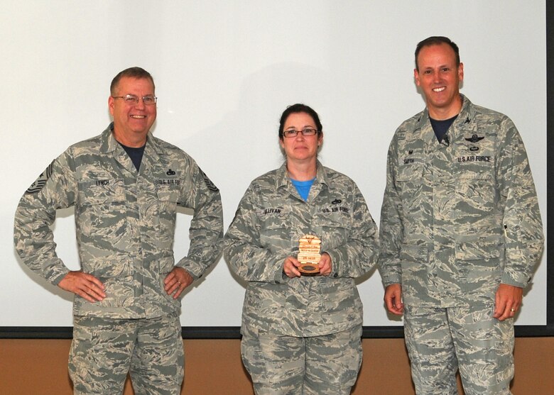 120th Airlift Wing Commander Col. Lee Smith and 120th AW Command Chief, Chief Master Sgt. Steven Lynch, present the Noncommissioned Officer of the Quarter Award to Tech. Sgt. Deana Sullivan during a commander’s call held in the Larsen Room of the Wing Headquarters Building during the regularly scheduled drill August 13, 2016. (U.S. Air National Guard photo by Staff Sgt. Lindsey Soulsby)