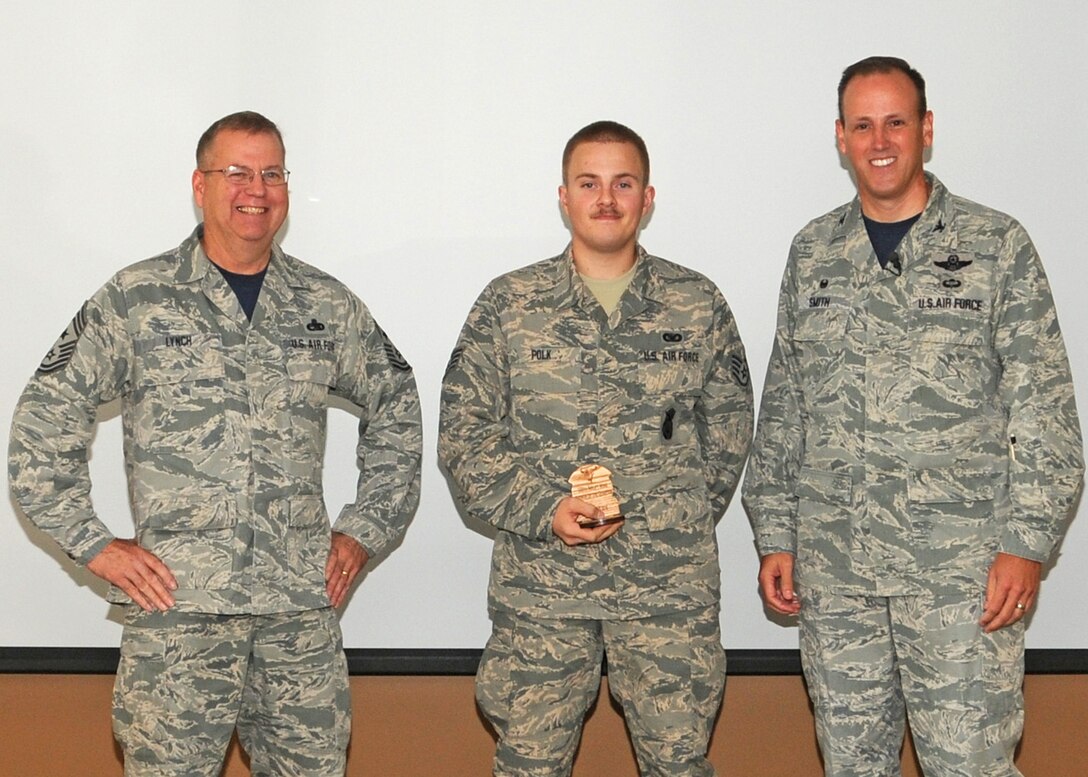 120th Airlift Wing Commander Col. Lee Smith and 120th AW Command Chief, Chief Master Sgt. Steven Lynch, present the Airman of the Quarter Award to Staff Sgt. Jedidiah Polk during a commander’s call held in the Larsen Room of the Wing Headquarters Building during the regularly scheduled drill August 13, 2016. (U.S. Air National Guard photo by Staff Sgt. Lindsey Soulsby)