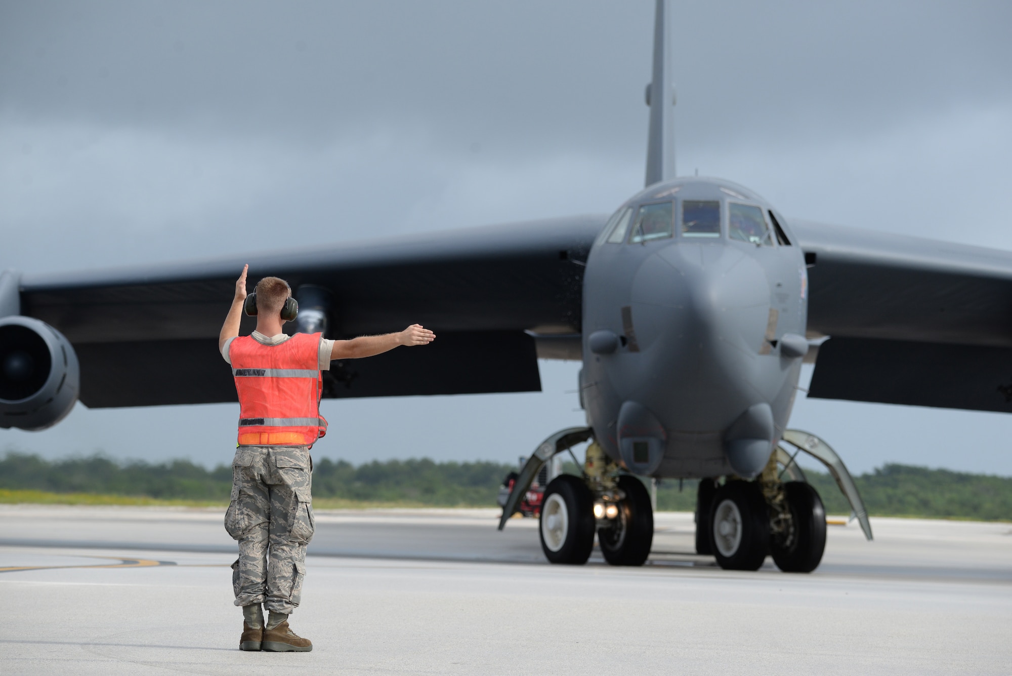 Senior Airman Logan Chufar, a 36th Expeditionary Aircraft Maintenance Squadron crew chief deployed from Minot Air Force Base, N.D., marshals a B-52 Stratofortress at Andersen Air Force Base, Guam, Aug. 24, 2016. The B-52s have served non-stop rotations since 2006, which have been shared between the bomber squadrons from Minot AFB, N.D., and Barksdale AFB, La. (U.S. Air Force photo by Airman 1st Class Jacob Skovo)