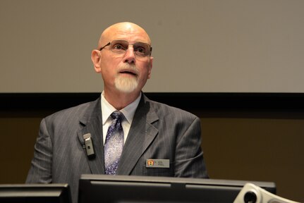 Dr. Kenneth P. Pisel, satellite program manager at the Joint Forces Staff College's (JFSC) Joint and Combined Warfighting School, provides remarks during a graduation ceremony at the University of Nebraska at Omahaâ€™s (UNO) Mammel Hall in Omaha, Neb., Aug. 25, 2016. During the ceremony, 18 Soldiers, Sailors, Airmen, Marines and Department of Defense (DoD) civilians were recognized for completing the first 10-week Joint and Combined Warfighting School satellite course at UNO. The course is the second of its kind - the pilot non-resident satellite JPME Phase II course in Tampa, Fla., was approved by Congress and launched in January 2013 - and represents the third option for field grade officers seeking JPME Phase II credit. Prior to the satellite courses, JPME Phase II courses were only offered at the National Defense University's JFSC in Norfolk, Va. One of nine DoD unified combatant commands, USSTRATCOM has global strategic missions assigned through the Unified Command Plan, which include strategic deterrence; space operations; cyberspace operations; joint electronic warfare; global strike; missile defense; intelligence, surveillance and reconnaissance; combating weapons of mass destruction; and analysis and targeting. (USSTRATCOM photo by U.S. Air Force Staff Sgt. Jonathan Lovelady)