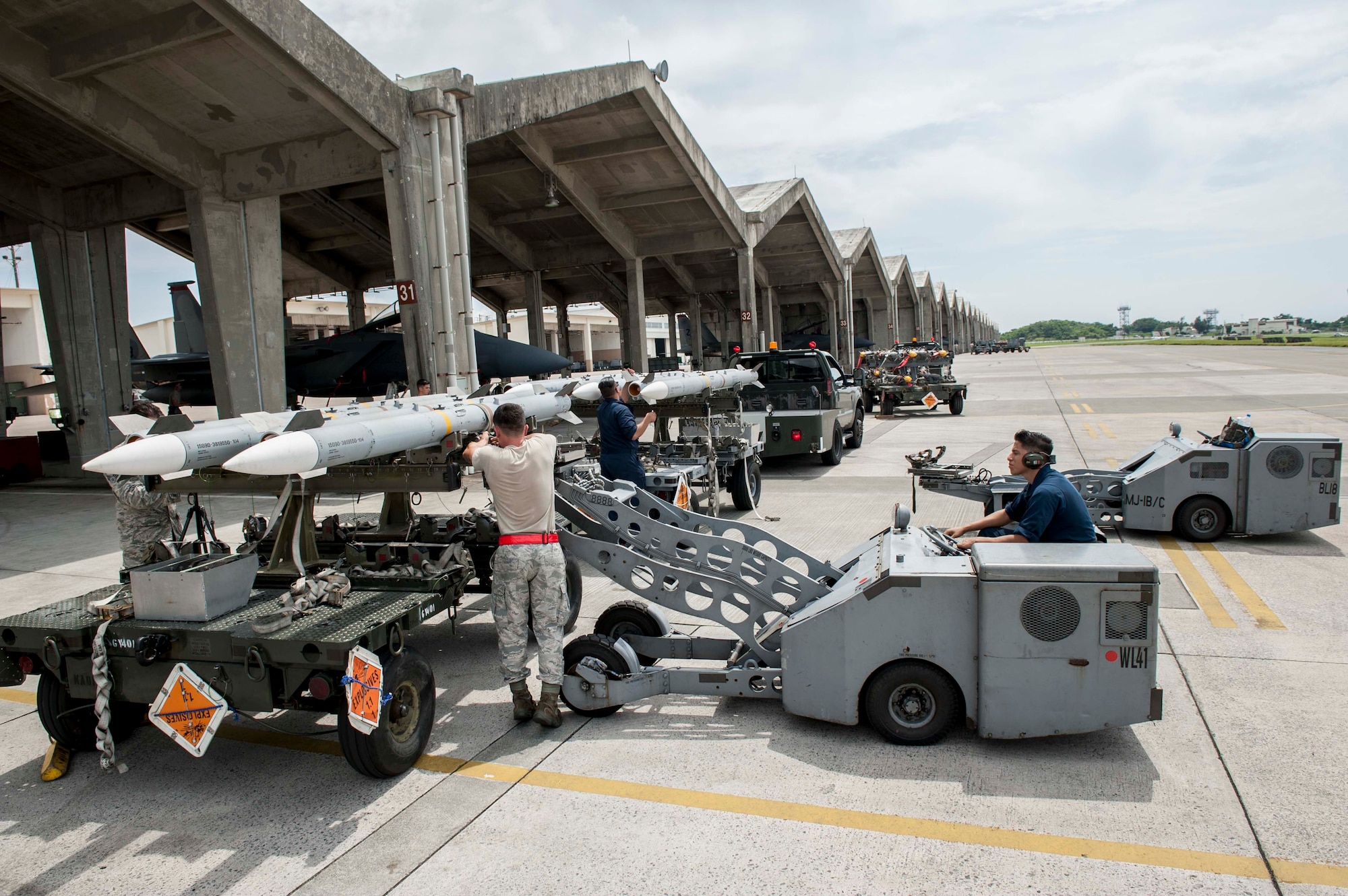 Maintainers from the 18th Aircraft Maintenance Squadron and pilots assigned to the 44th and 67th Fighter Squadrons conduct a mass aircraft generation exercise Aug. 22 and 23, at Kadena Air Base, Japan. Maintainers loaded AIM-9 sidewinder missiles, AIM-120 advanced medium-range air-to-air missiles, flares, and M-61A1 cannon rounds onto F-15 Eagles, before the aircraft taxied and were dispersed around the flight line. Kadena participates in a variety of routine training exercises throughout the year to maintain a consistent high standard of readiness and expertise. F-15s assigned to Kadena Air Base taxied on the flight line during a training exercise Aug. 23 while loaded with live ammunition. This training was not in response to or in anticipation of any regional concerns. While no planes took off from the flightline, this routine exercise helped ensure Kadena’s ability to provide air superiority in the defense of Japan and promoting peace and stability throughout the Indo-Asia-Pacific region. (U.S. Air Force photo by Senior Airman Peter Reft/Released)
