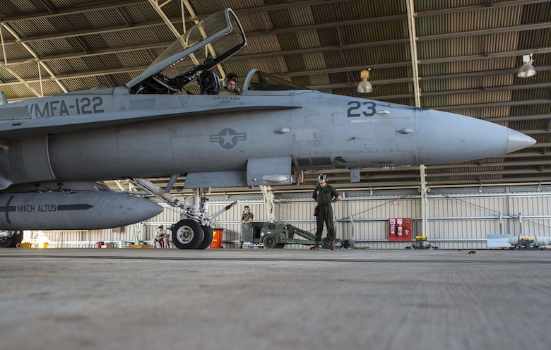 U.S. Marine Corps Maj. David Dunsworth, an F/A-18C Hornet pilot with Marine Fighter Attack Squadron (VMFA) 122, completes a preflight check as Lance Cpl. Luke Zeisloft, a powerline Marine assigned to VMFA-122, stands by during Southern Frontier at Royal Australian Air Force Base Tindal, Australia, Aug. 24, 2016. VMFA-122 provided close air support to ground units at Bradshaw Range Complex during the training. Southern Frontier is a three week unit level training evolution helping the flying squadron gain qualifications and experience in low altitude, air ground, high explosive ordnance delivery. (U.S. Marine Corps photo by Cpl. Nicole Zurbrugg)