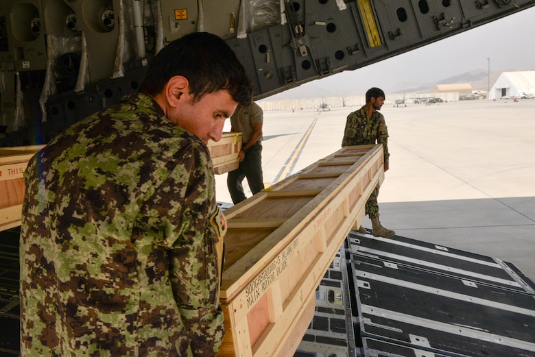 Members from the Afghan air force unload crates containing rotar blades at Hamid Karzai International Airport, Kabul, Afghanistan, Aug. 25, 2016. The blades were delivered on a C-17 Globemaster III from Travis Air Force Base, Calif., along with the final four MD-530 Cayuse Warrior helicopters the AAF will receive, bringing the total number to 27. (U.S. Air Force photo by Tech. Sgt. Christopher Holmes)