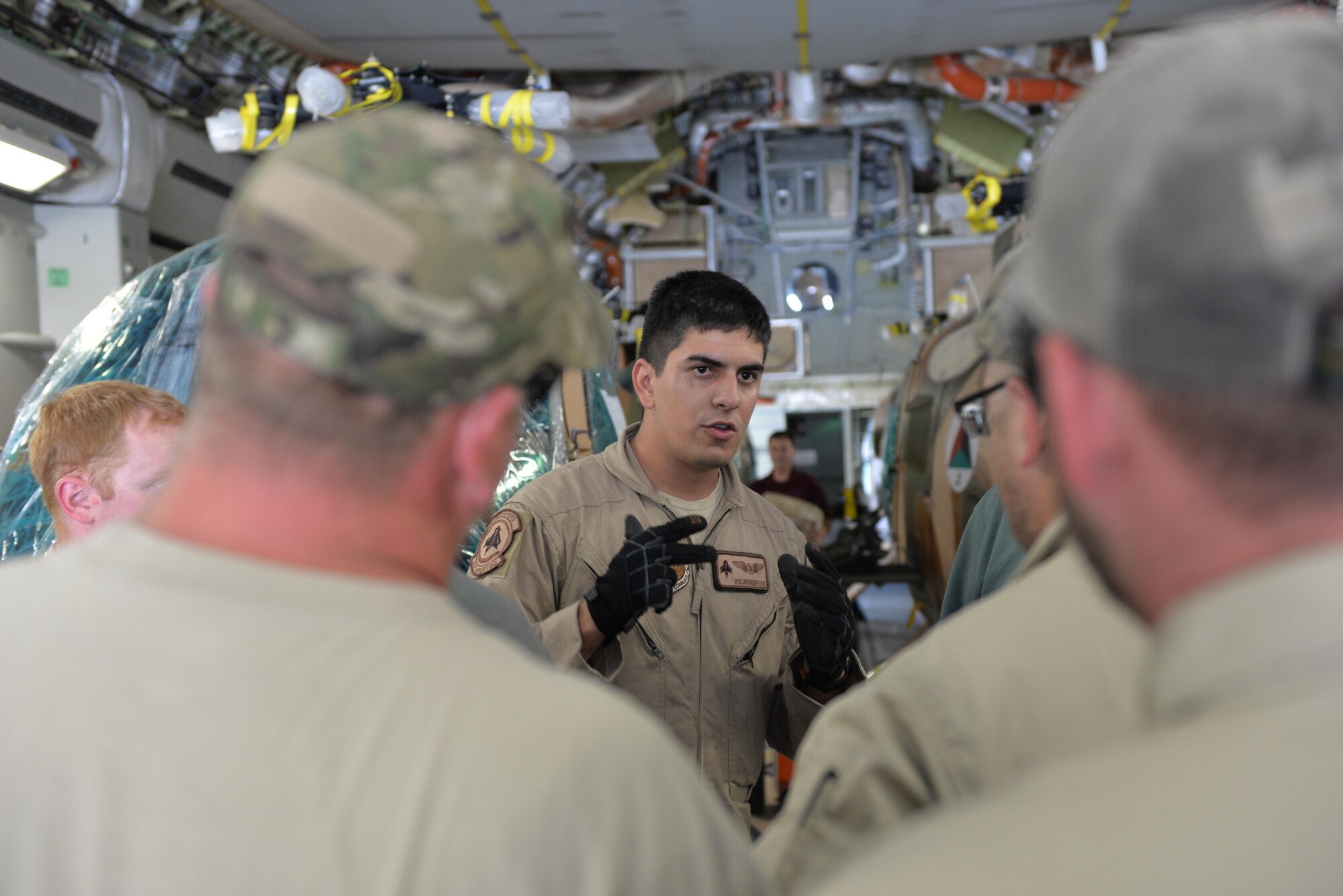 Airman 1st Class Andrew Flint, Travis Air Force Base, Calif., briefs contractors before unloading MD-530 Cayuse Warrior helicopters at Hamid Karzai International Airport, Afghanistan, Aug. 25, 2016. Four helicopters were delivered via a C-17 Globemaster III. These helicopters are scheduled to be the final four delivered to the Afghan air force, bringing the AAF total number of MD-530s to 27. (U.S. Air Force photo by Tech. Sgt. Christopher Holmes)