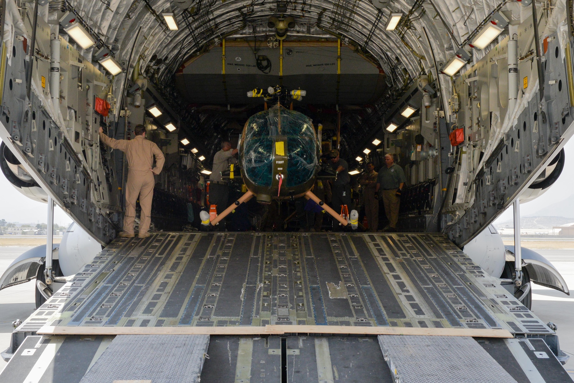 Four new MD-530 Cayuse Warrior helicopters arrived at Hamid Karzai International Airport, Afghanistan, Aug. 25, 2016, via a C-17 Globemaster III. The four helicopters, scheduled to be the final four delivered to the Afghan air force, brings the AAF total number of MD-530s to 27. (U.S. Air Force photo by Tech. Sgt. Christopher Holmes) 