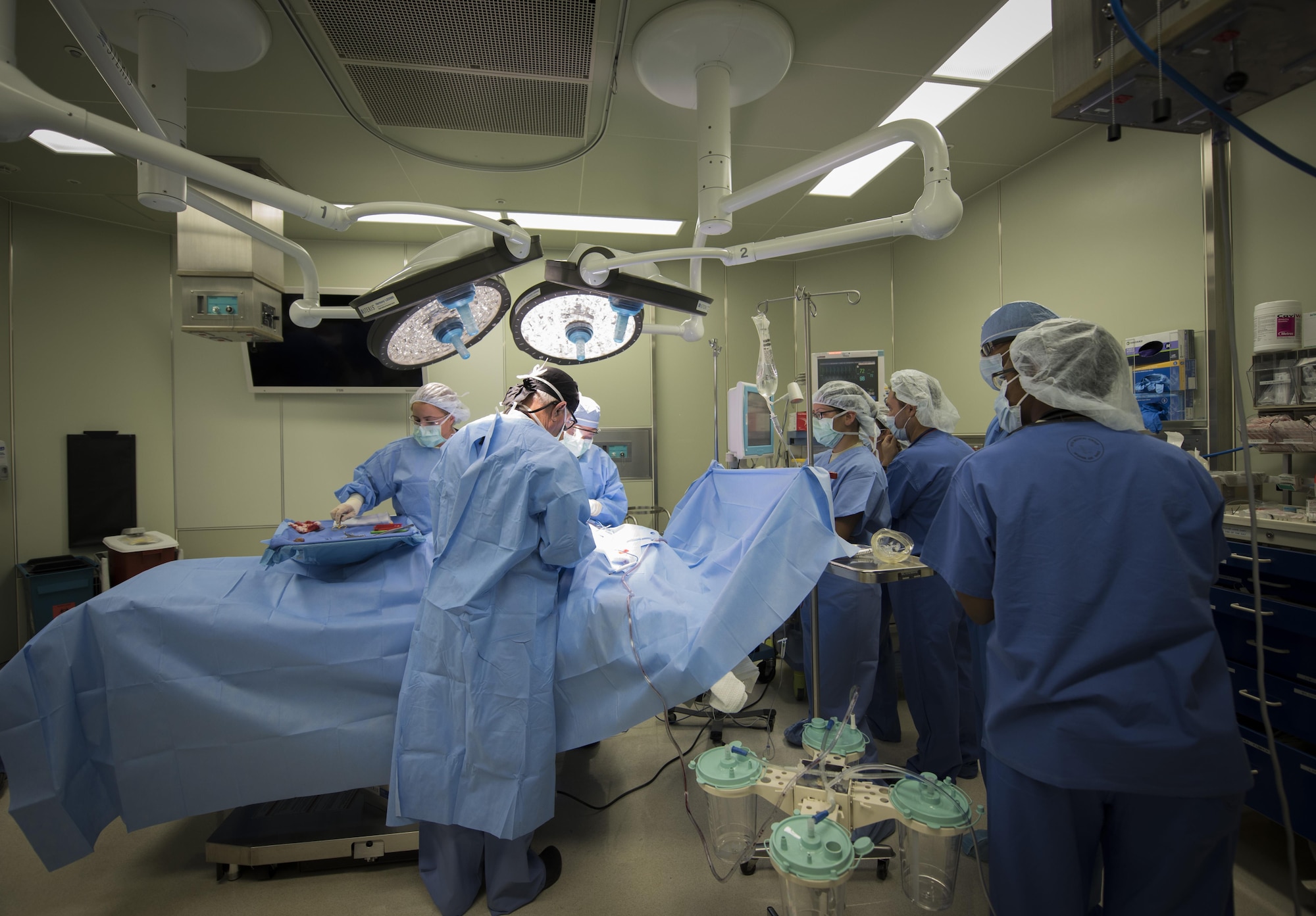 U.S. Army and Air Force medics observe a surgery during MEDEX 16, a medical exercise held at Misawa Air Base, Japan, Aug. 24, 2016.  The patient had surgery on his back to remove a mass from his body. MEDEX 16 provided a unique training opportunity, enhancing the capabilities of its participants by using real patients instead of scenario based ones. (U.S. Air Force photo by Tech. Sgt. Araceli Alarcon)