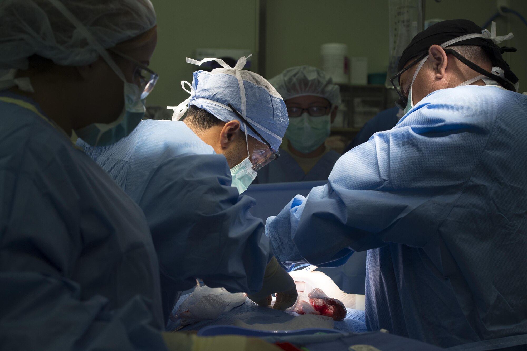 U.S. Army Capt. Gregory Lacy, 228th Combat Support Hospital urologist, center, assists U.S. Army Col. George Newton, 228th CSH general surgeon, right, while Spc. Marinel Armstead, 228th CSH surgical scrub technician, left, observes during MEDEX 16 at Misawa Air Base, Japan, Aug. 24, 2016.  During the medical exercise, Soldiers integrated with Airmen to train for responding to potential real world contingency operations. (U.S. Air Force photo by Tech. Sgt. Araceli Alarcon)