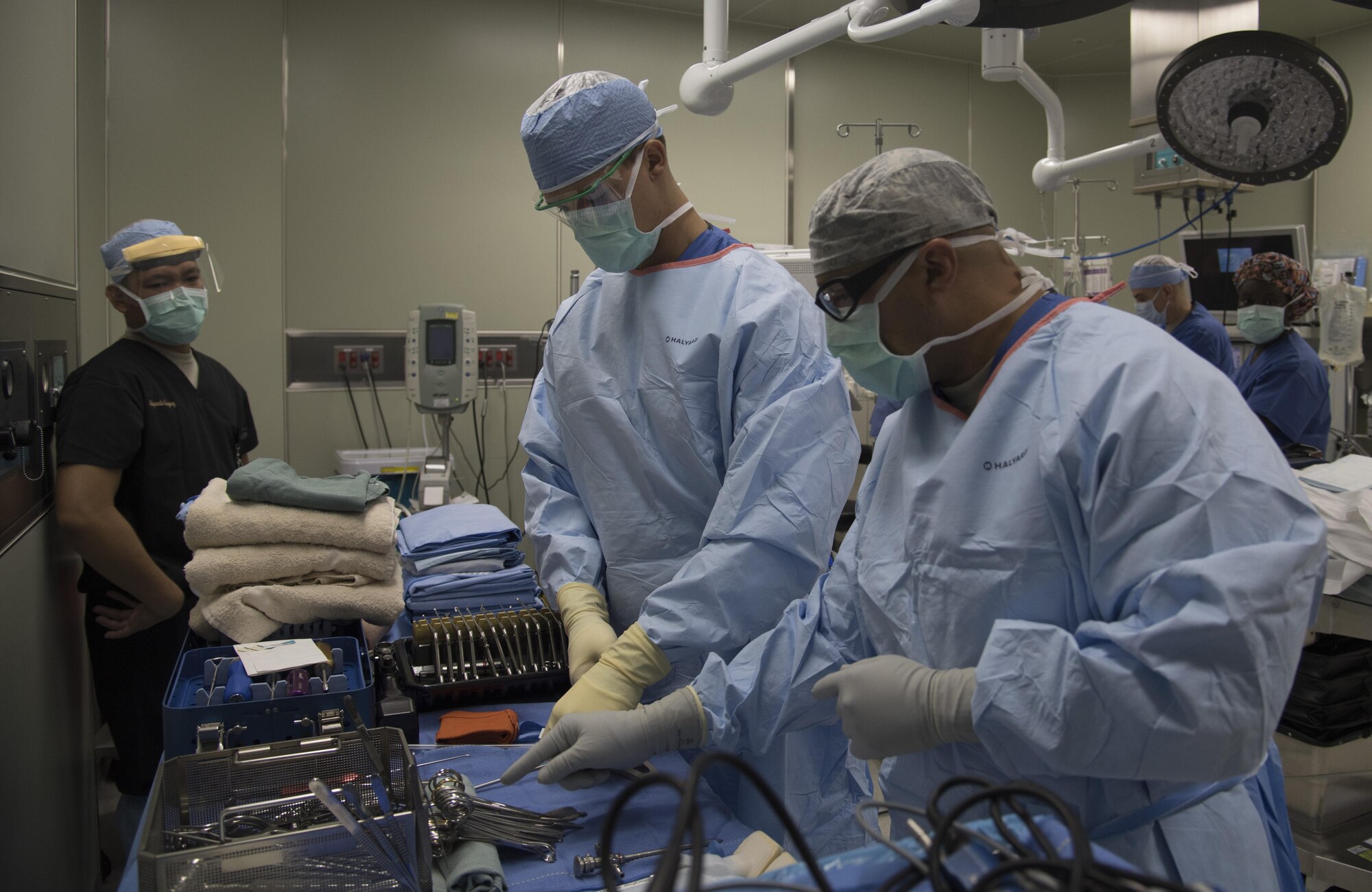 U.S. Air Force Staff Sgt. Nandieboy Merjilla, an orthopedic technician, left, Airman 1st Class Thor Shaefer, a surgical technician, center, both assigned to the 35th Medical Group, and U.S. Army Sgt. Marco Martinez, a surgical technician with the 228th Combat Support Hospital in San Antonio, Texas, share surgical techniques while setting up the surgical back table for surgery during MEDEX 16 at Misawa Air Base, Japan, Aug. 25, 2016. Back tables hold medical instrumentation which are prepared by technicians who hand the doctors the tools to be used during a surgery. (U.S. Air Force photo by Airman 1st Class Sadie Colbert)