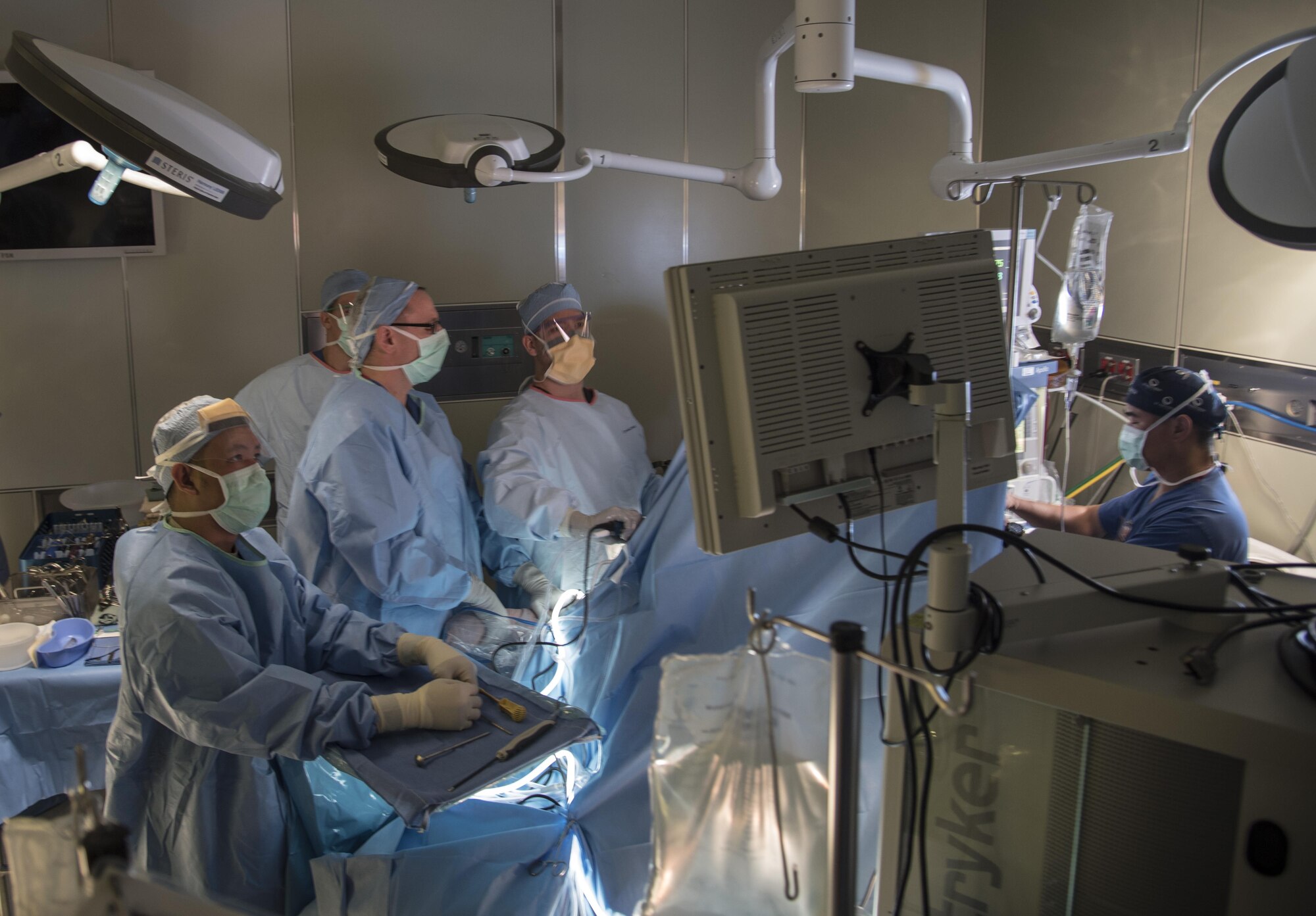 U.S. Army and Air Force medics observe a monitor while conducting a surgical operation during MEDEX 16, a medical exercise held at Misawa Air Base, Japan, Aug. 25, 2016. The training enabled Army and Air Force medical staff to work together and exchange surgical techniques, while saving approximately $250,000 by eliminating the need to send the patients to outside care facilities. (U.S. Air Force photo by Airman 1st Class Sadie Colbert)