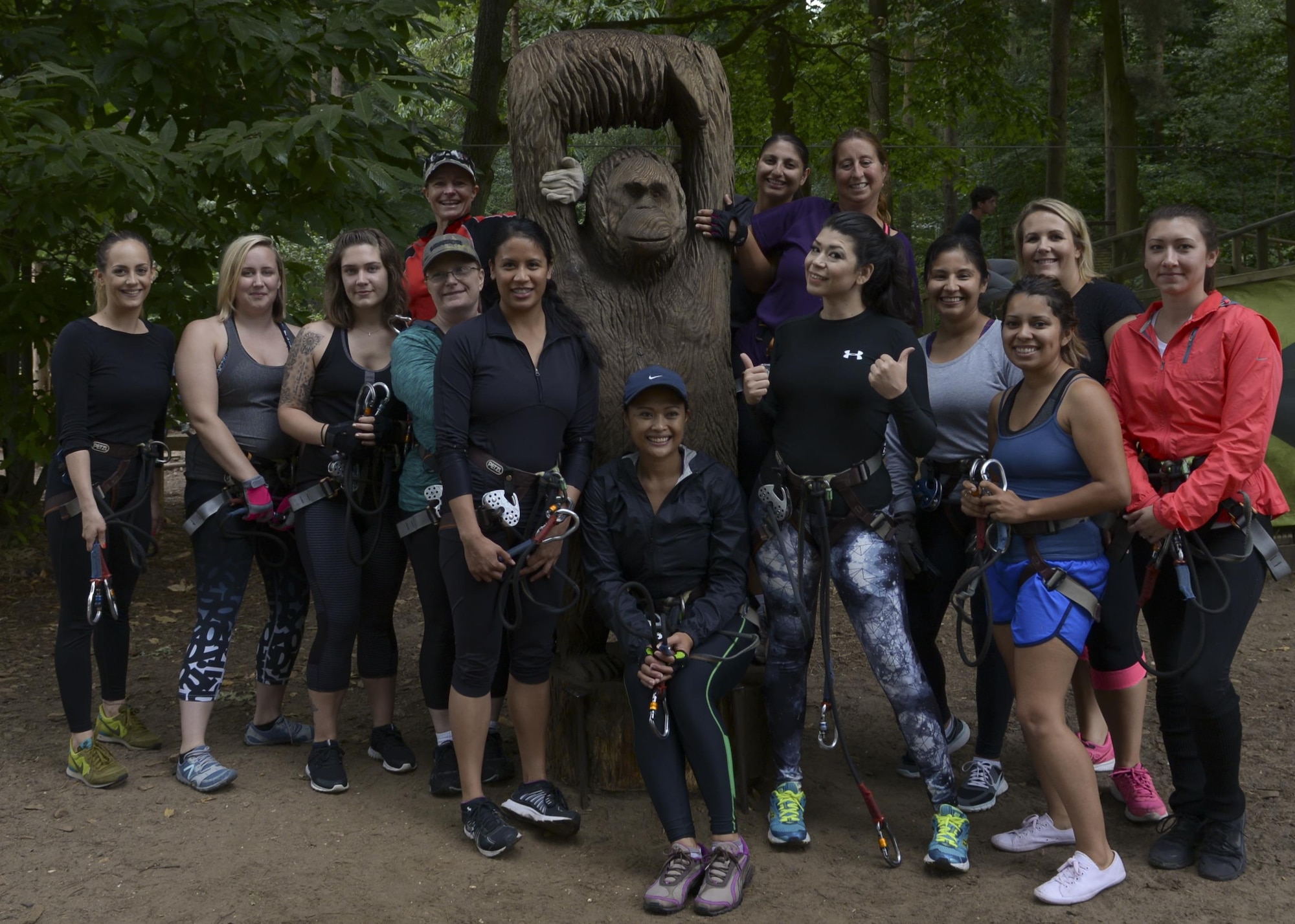 Spouses of U.S. Air Force Airmen assigned to RAF Mildenhall pose for a group photo before participating in a high-ropes course during the “Spouses on Belay” event Aug. 19, 2016, at Thetford, England. The lessons imparted during the event were taught by spouses, for spouses with the goal to train them to continually strive to achieve and maintain a well-balanced lifestyle. (U.S. Air Force photo by Staff Sgt. Victoria H. Taylor)