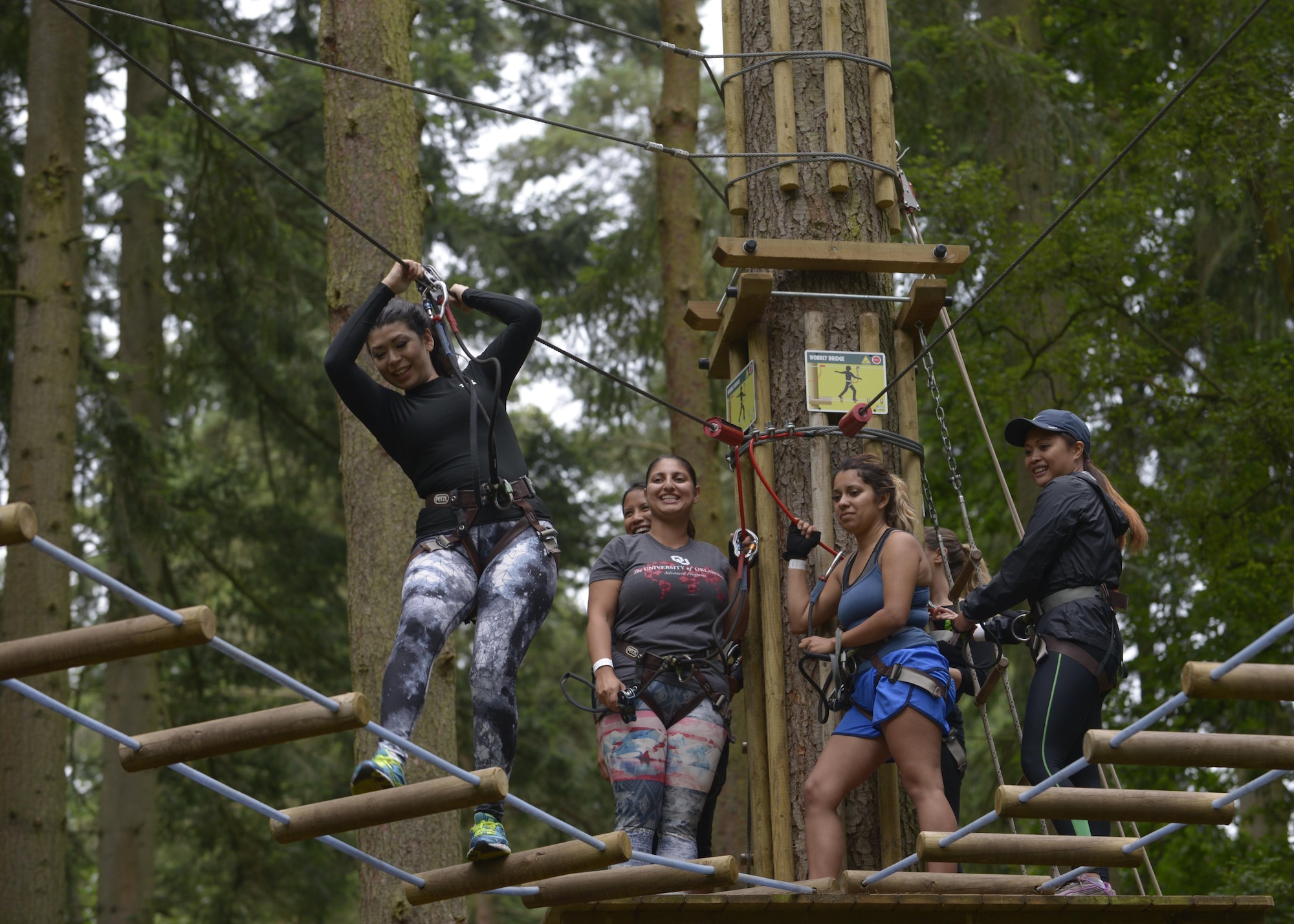 Spouses of U.S. Air Force Airmen assigned to RAF Mildenhall participate in a high-ropes course during the “Spouses on Belay” event Aug. 19, 2016, at Thetford, England. The lessons imparted during the event were taught by spouses, for spouses with the goal to train them to continually strive to achieve and maintain a well-balanced lifestyle. (U.S. Air Force photo by Staff Sgt. Victoria H. Taylor)