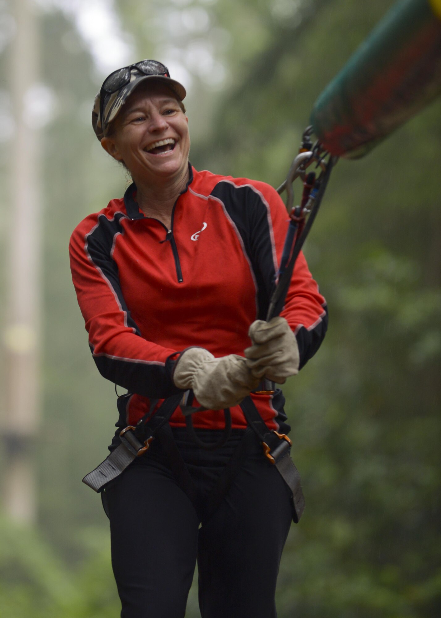 Dana Howard, RAF Mildenhall Spouse Resilience Team leader, completes a portion of a high-ropes course while participating in “Spouses on Belay” Aug. 19, 2016, at Thetford, England. The lessons imparted during the event were taught by spouses, for spouses with the goal to train them to continually strive to achieve and maintain a well-balanced lifestyle. (U.S. Air Force photo by Staff Sgt. Victoria H. Taylor)