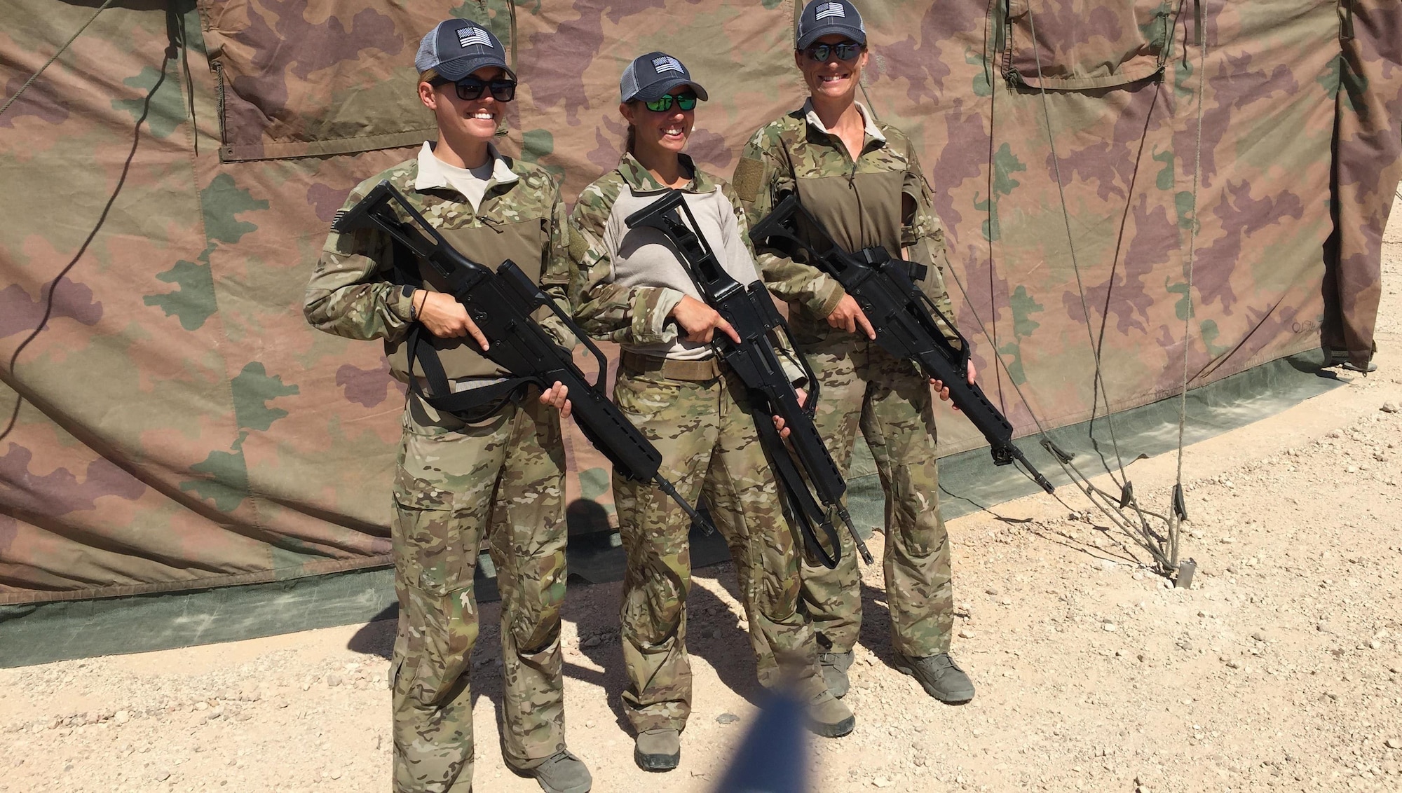 USA Team 2, Capt. Amy Moore, Maj. Caitlin Harris and Maj. Jamie Turner, proudly display their G-36 Assault Rifles prior to entering the scoring tent to sign their targets.  Jamie finished 40th of 78 competitors.