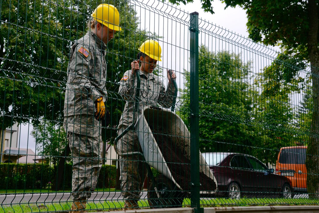 U.S. Army Spc. Ashley Clark (left) and Spc. Raven Henderson (right), both assigned to the 375th Engineer Company, 467th Engineer Battalion, 926th Engineer Brigade, 412th Theater Engineer Command, assist with constructing a fence during a Humanitarian Civil Assistance (HCA) project, in Sauliai, Lithuania, Aug. 18, 2016. As part of the European Command’s (EUCOM) Humanitarian and Civic Assistance Program, the 375th Engineer Company, 457th Civil Affairs Battalion and the Lithuanian military collaborate to renovate the fence at Kudikiu Namai, an orphanage for Lithuanian children up to the age of 6, in Sauliai, Lithuania, August 8-26, 2016. The Humanitarian and Civic Assistance Program is a series of medical and engineering engagements in several European countries in support of strategic, theater, operational and tactical objectives. (U.S. Army photo by Pfc. Emily Houdershieldt)