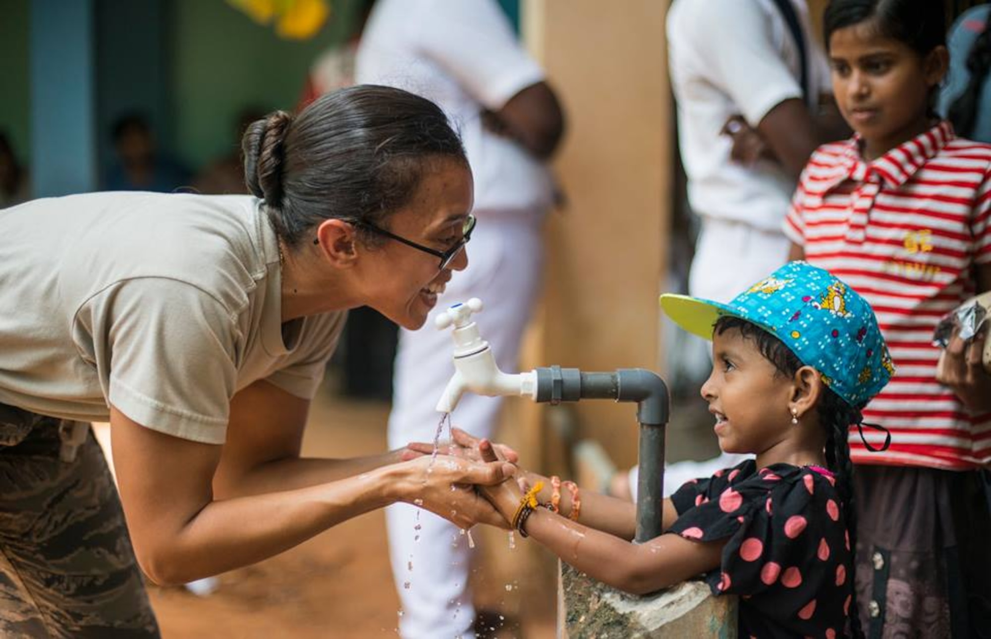 Staff Sgt. Yesenia Benjamin, an 18th Medical Group public health technician, teaches a Sri Lankan child how to properly wash her hands during Pacific Angel 16-3 in Jaffna, Sri Lanka, Aug. 16, 2016. Now entering its ninth year, Operation Pacific Angel ensures that the region’s militaries are prepared to work together to address humanitarian crises. Since 2007, Pacific Angel operations have improved the lives of tens of thousands of people. (U.S. Air Force photo/Senior Airman Brittany A. Chase)