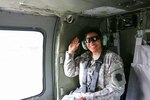 Sgt. Nilda Jenkins, mortuary affairs noncommissioned officer assigned to the Pennsylvania National Guard's 28th Infantry Division, rides in a UH-60 Black Hawk on the way to her reenlistment ceremony at Camp Film City, Kosovo, April 18, 2016. 