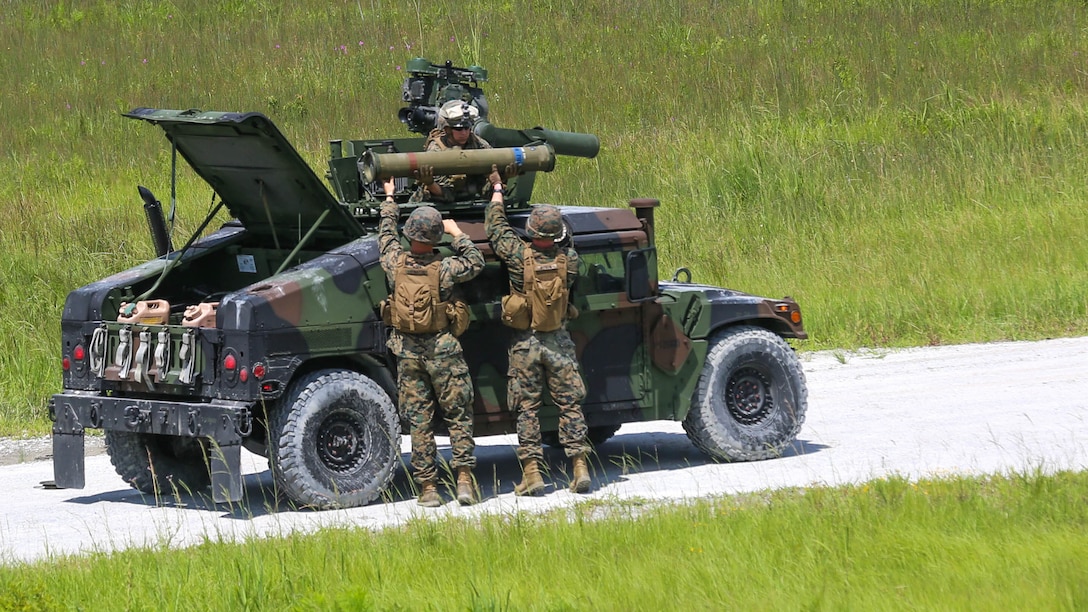 Marines with 3rd Battalion, 6th Marine Regiment pass a Tube-launched, Optically tracked, Wire-guided (TOW) missile for the gunner to load during a battle drill at Marine Corps Base Camp Lejeune, North Carolina, Aug. 23, 2016.  The Marines performed basic fire and maneuver drills with the Saber Missile System replicating combat situations. 