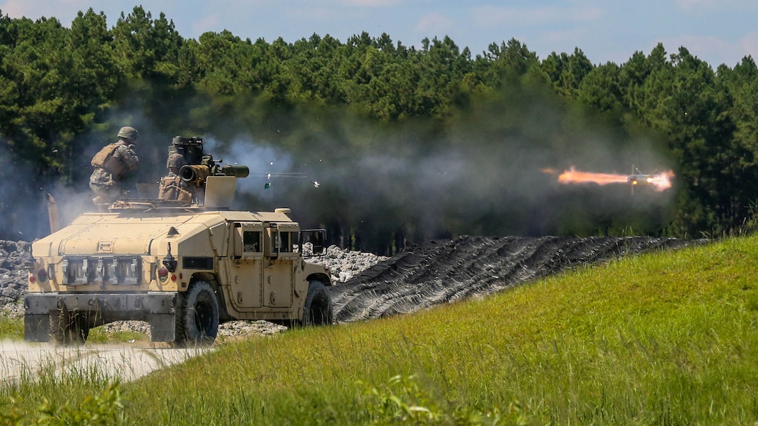 A Marine with 3rd Battalion, 6th Marine Regiment helps the gunner fire a Tube-launched, Optically tracked, Wire-guided (TOW) missile during a battle drill at Marine Corps Base Camp Lejeune, North Carolina, Aug. 23, 2016.  The more experienced Marines got up and helped guide the new Marines who were shooting the weapon system for the first time. 
