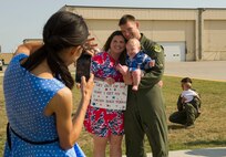 Capt. Joshua Isenga, 69th Bomb Squadron aircrew member, poses for a photo with his family at Minot Air Force Base, N.D., Aug. 23, 2016. This was the unit’s last deployment to Guam for a while, as they will now support the Central Command mission out of Al Udeid Air Base. (U.S. Air Force photo/Senior Airman Apryl Hall)