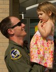 Capt. Chauncy Rockwell, 69th Bomb Squadron pilot, greets his daughter during a welcome home event at Minot Air Force Base, N.D., Aug. 23, 2016. The 69th BS was deployed to Andersen AFB, Guam in support of the continuous bomber presence mission. (U.S. Air Force photo/Senior Airman Apryl Hall)