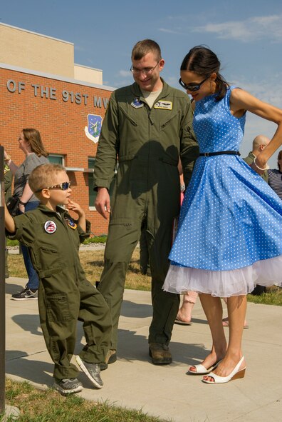 Capt. Samuel Wright, 69th Bomb Squadron assistant flight commander, visits with family members during a welcome home event at Minot Air Force Base, N.D., Aug. 23, 2016. The six-month deployment was the unit’s last to Andersen AFB, Guam before they begin supporting Central Command’s mission in the Middle East. (U.S. Air Force photo/Senior Airman Apryl Hall)