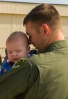 Capt. Joshua Isenga, 69th Bomb Squadron aircrew member, holds his son at Minot Air Force Base, N.D., Aug. 23, 2016. The 69th BS was deployed to Andersen AFB, Guam in support of the continuous bomber presence mission. (U.S. Air Force photo/Senior Airman Apryl Hall)