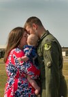 Capt. Joshua Isenga, 69th Bomb Squadron aircrew member, embraces his family at Minot Air Force Base, N.D., Aug. 23, 2016. This was the unit’s last deployment to Guam for a while, as they will now support the Central Command mission out of Al Udeid Air Base. (U.S. Air Force photo/Senior Airman Apryl Hall)