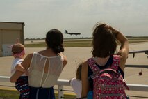 Family members of the 69th Bomb Squadron watch a B-52 land at Minot Air Force Base, N.D., Aug. 23, 2016. The aircrew was returning from a six-month deployment to Andersen Air Force Base, Guam. (U.S. Air Force photo/Senior Airman Apryl Hall)