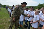 Military child Madison Sours, 10, responds to a question from the Adjutant General of Maryland Maj. Gen. Linda Singh as part of "Military Experience Day" during Operation Purple Camp at Elk Neck State Park in North East, Md. Aug. 16, 2016. Singh arrived via Maryland National Guard Lakota helicopter to greet the 100 military children in attendance at the camp. 