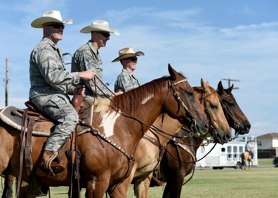 [From left] U.S. Air Force Col. Todd Hohn, 97th Air Mobility Wing commander, U.S. Air Force Chief Master Sgt. Philp Eckenrod, 97th AMW command chief, and U.S. Air Force Col. Charles Ohliger, 97th AMW vice commander, sit on top of horses during the 18th annual Cattle Drive on Aug. 25, 2015, Altus Air Force Base, Okla. Approximately 18 Texas Longhorn cattle were driven through Altus AFB at this year's base Cattle Drive which provided opportunity for community members to share part of their culture with the Airmen and their families.
 (U.S. Air Force photo by Airman 1st Class Kirby Turbak/Released)
