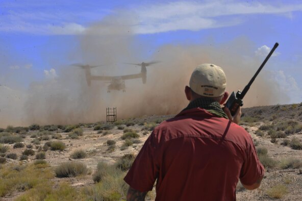 A combat controller directs a CV-22 for landing during a training exercise in Green River, Utah, July 26, 2016. The full mission profile provided these Airmen an opportunity to practice their core competencies and hone their skills in unfamiliar terrain similar to what they might encounter overseas. (U.S. Air Force photo/Staff Sgt. Eboni Reams)