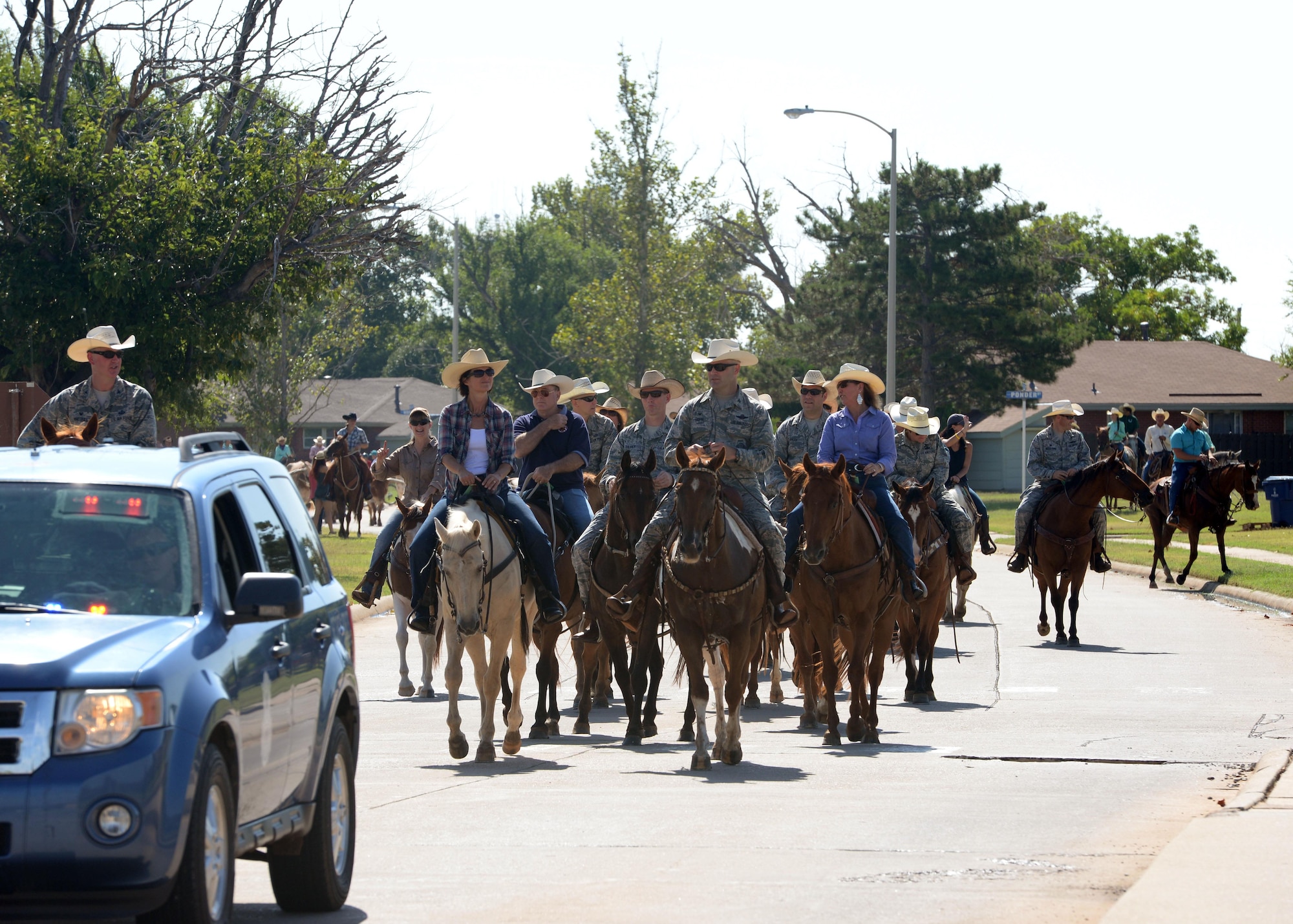 Altus Air Force Base leaders and local members of the community lead Texas Longhorn cattle through Altus AFB during the 18th annual Cattle Drive, Aug. 25, 2016. Approximately 18 Texas Longhorn cattle were driven through Altus AFB at this year’s base Cattle Drive which provided opportunity for community members to share part of their culture with the Airmen and their families. (U.S. Air Force photo by Airman 1st Class Cody Dowell)	