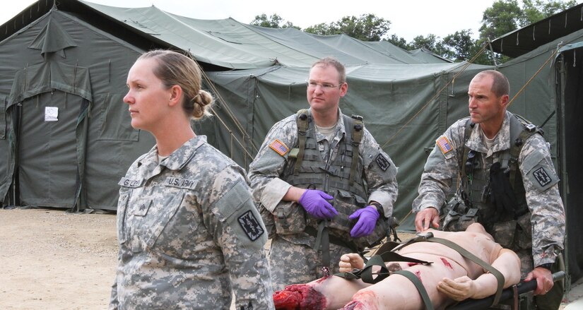 FORT MCCOY, Wis -- Army Reserve Soldiers from the 75th Combat Support Hospital out of San Antonio, Texas, lift a mannequin with grevious leg injuries and prepare for medical evacuation during the Global Medic Exercise at Fort McCoy, Wis. on Aug. 20, 2016. Global Medic is an inter-service training event that develops and evaluates the collective skills of Army Reserve Soldiers and other service members in a collaborative environment. (U.S. Army Reserve photo by Spc. Christopher A. Hernandez, 345th Public Affairs Detachment)