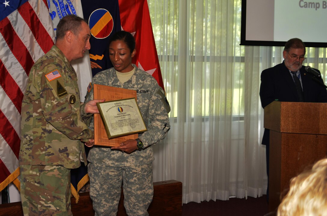 Command Sgt. Maj. David S. Davenport Sr., the U.S. Army Training and Doctrine Command senior enlisted leader, presents Sgt. 1st Class JaDrian Whitfield with a certificate of achievement for winning the 2016 U.S. Army Training and Doctrine Command Reserve Instructor of the Year competition. Whitfield, a a human intelligence collector instructor assigned 80th Training Command, also accepted an IOY plaque from TRADOC Commander Gen. David Perkins during a ceremony at Fort Eustis, Va. Aug. 24, 2016.