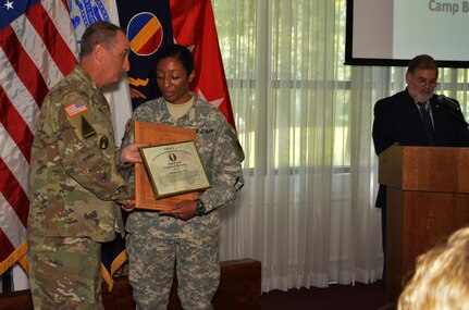 Command Sgt. Maj. David S. Davenport Sr., the U.S. Army Training and Doctrine Command senior enlisted leader, presents Sgt. 1st Class JaDrian Whitfield with a certificate of achievement for winning the 2016 U.S. Army Training and Doctrine Command Reserve Instructor of the Year competition. Whitfield, a a human intelligence collector instructor assigned 80th Training Command, also accepted an IOY plaque from TRADOC Commander Gen. David Perkins during a ceremony at Fort Eustis, Va. Aug. 24, 2016.