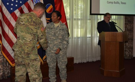 Gen. David Perkins, commander U.S. Army Training and Doctrine Command, congratulates Sgt. 1st Class JaDrian Whitfield winner of the 2016 U.S. Army Training and Doctrine Command Reserve Instructor of the Year competition. Whitfield, a human intelligence collector instructor assigned to the 80th Training Command received the award during a ceremony at Fort Eustis, Va. Aug. 24, 2016.