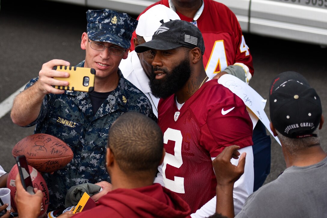 Chief Petty Officer Kenneth Zumwalt, Fleet Readiness Center Mid-Atlantic Detachment Washington administration lead, poses for a selfie with DeAngelo Hall, Washington Redskins safety, at the West Fitness Center’s field on Joint Base Andrews, Md., Aug. 25, 2016. The practice was followed by an autograph meet and greet with fans as a way for the Redskins to show their appreciation for the men and women in the armed forces. (U.S. Air Force photo by Airman 1st Class Valentina Lopez)
