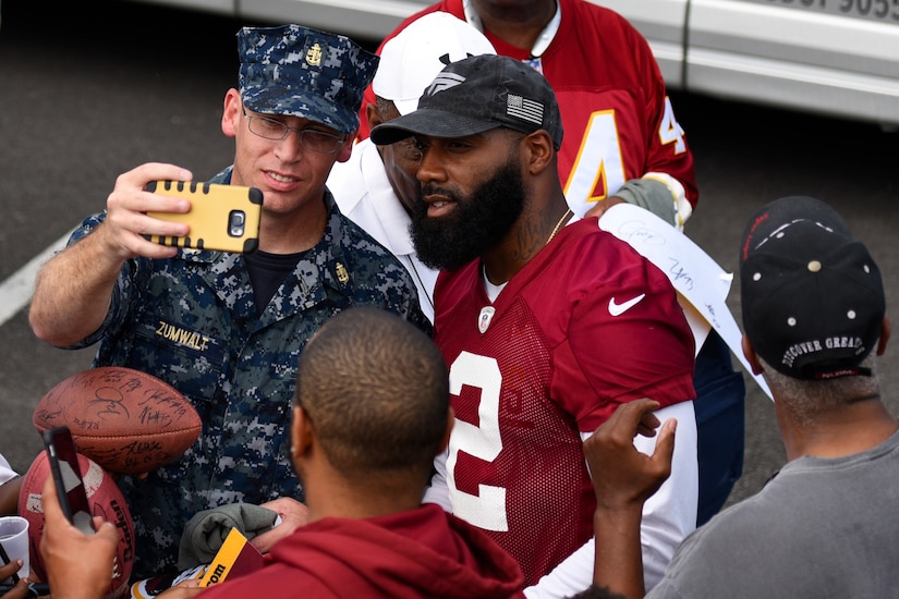 Chief Petty Officer Kenneth Zumwalt, Fleet Readiness Center Mid-Atlantic Detachment Washington administration lead, poses for a selfie with DeAngelo Hall, Washington Redskins safety, at the West Fitness Center’s field on Joint Base Andrews, Md., Aug. 25, 2016. The practice was followed by an autograph meet and greet with fans as a way for the Redskins to show their appreciation for the men and women in the armed forces. (U.S. Air Force photo by Airman 1st Class Valentina Lopez)
